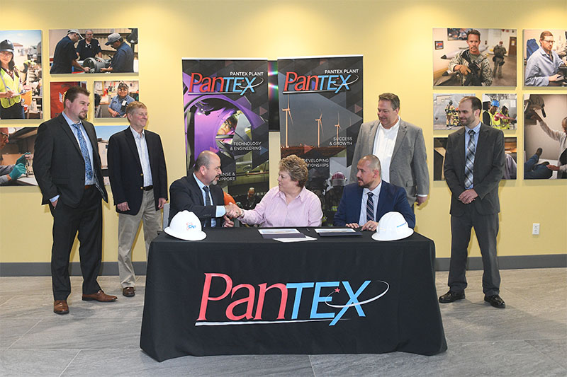 Kelly Delgado-Goudschaal (c), Pantex supply chain manager, signs the first Consolidated Nuclear Security, LLC Mentor-Protégé agreement at Pantex with brothers Samuel and Saul Maldonado, Chief Executive Officer and President respectively of SAM Engineering & Surveying, Inc.